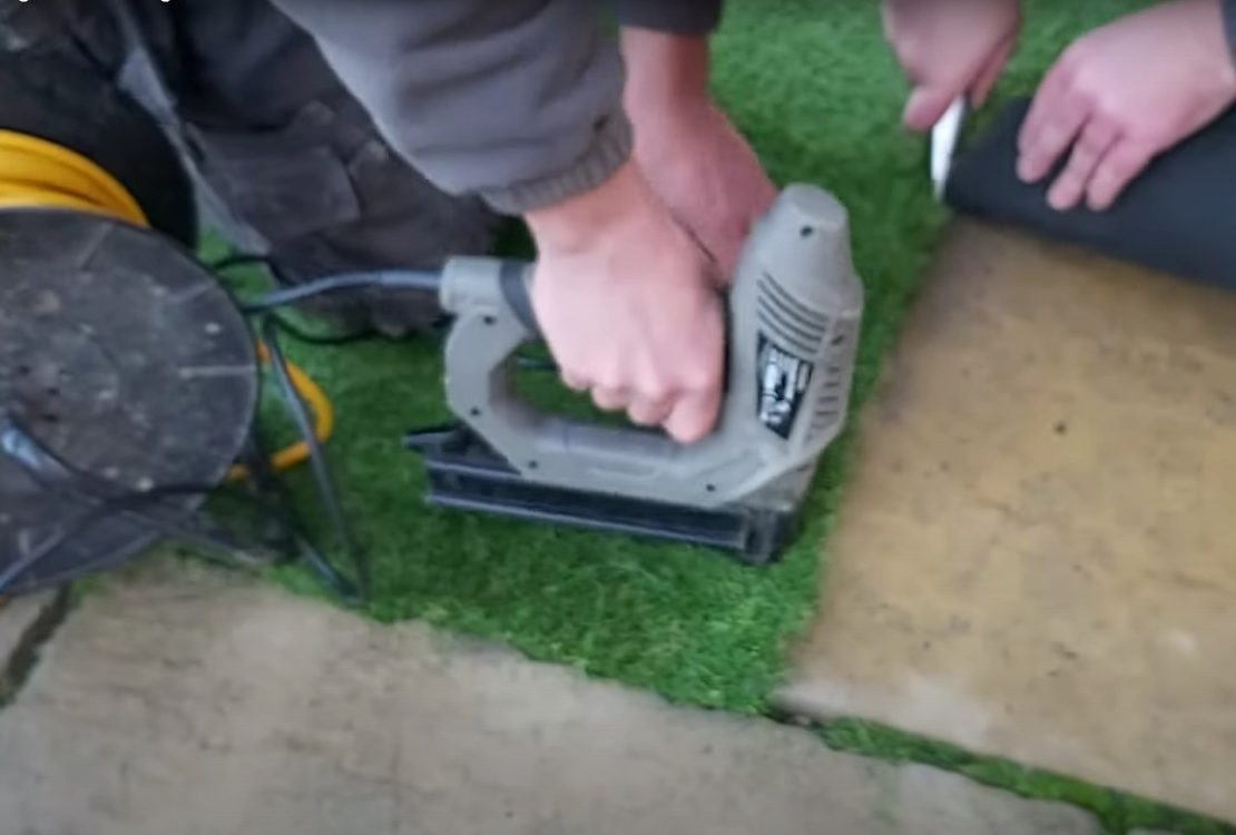 Cutting and fixing and artificial grass lawn